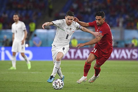 Italy's Jorginho, left, fights for the ball with Turkey's Irfan Kahveci during the Euro 2020 soccer championship group A match between Italy and Turkey. (Photo | AP)
