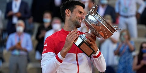 Novak Djokovic holds the cup after defeating Stefanos Tsitsipas during their final match of the French Open tennis tournament at the Roland Garros stadium. (Photo | AP)