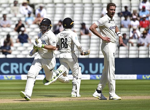 England's Stuart Broad, right, looks on as New Zealand captain Tom Latham, left, and Devon Conway run between the wickets to score during the fourth day of the second cricket test match. (Photo | AP)