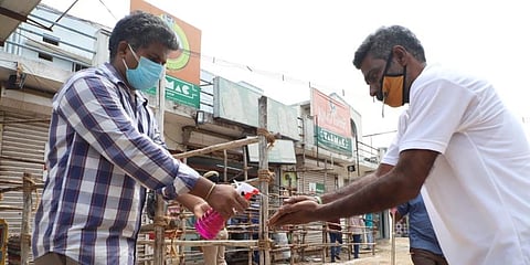 A man sanitises his hands at a Tasmac store before purchasing liquor in Vellore. (Photo | S Dinesh, EPS)