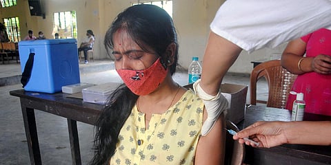 A beneficiary reacts while getting a dose of COVID-19 vaccine at SB Deorah College, in Guwahati. (Photo| ANI)
