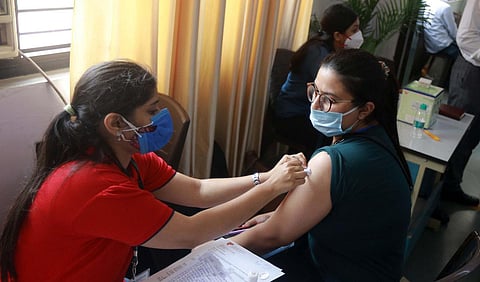 A health worker administers COVID-19 vaccine dose to a student at a vaccination centre organised for the students travelling abroad for higher studies, in New Delhi. (Photo | Shekhar Yadav, EPS)