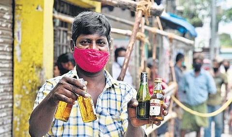 A man showing the bottles of liquor he bought on Monday | P Jawahar