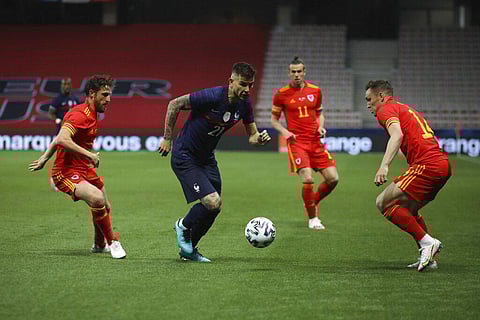 France's Lucas Hernandez, center, controls the ball past Wales' Connor Roberts, right during the international friendly soccer match between France and Wales. (Photo | AP)
