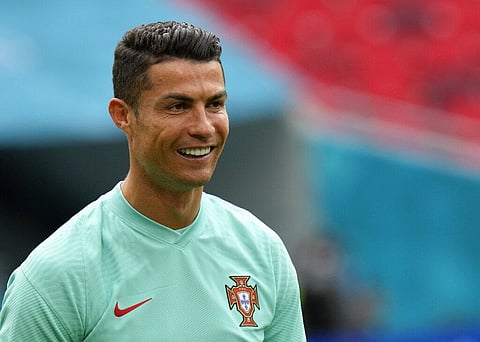 Portugal's Cristiano Ronaldo smiles during a team training session at the Ferenc Puskas stadium in Budapest, Monday, June 14, 2021. (Photo | AP)