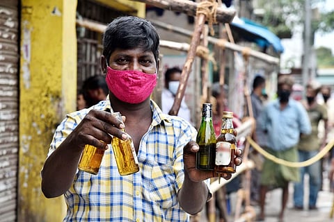 A man showing the bottles of liquor he bought on Monday. (Photo | P Jawahar, EPS)