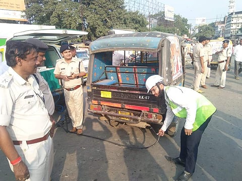 Officials carrying out vehicle pollution testing. (Photo | EPS)