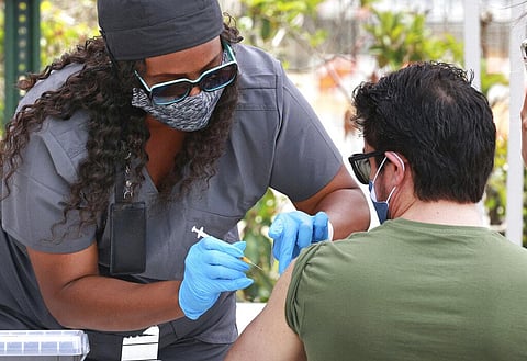 An Orange County resident receives the COVID-19 vaccine at the Florida Division of Emergency Management mobile vaccination site at Camping World Stadium in Orlando. (Photo | AP)