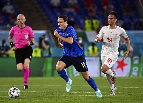 Italy's Federico Chiesa, centre, and Switzerland's Mario Gavranovic battle for the ball during the Euro 2020 soccer championship group A match between Italy and Switzerland. (Photo | AP)