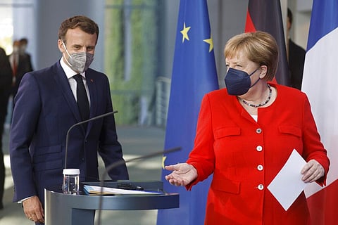 German Chancellor Angela Merkel, right, and French President Emmanuel Macron give a joint statement to journalists, at the chancellery in Berlin, Germany, Friday June 18, 2021. (Photo | AP)
