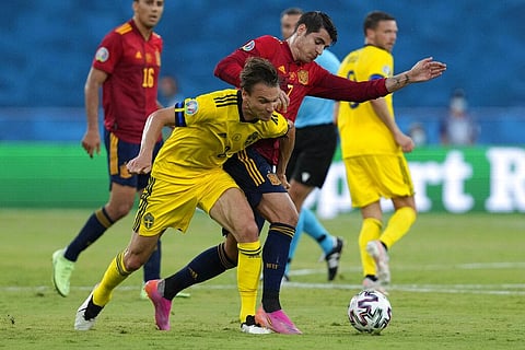 Sweden's Sebastian Larsson, left, challenges for the ball with Spain's Alvaro Morata during the Euro 2020 soccer championship. (Photo | AP)