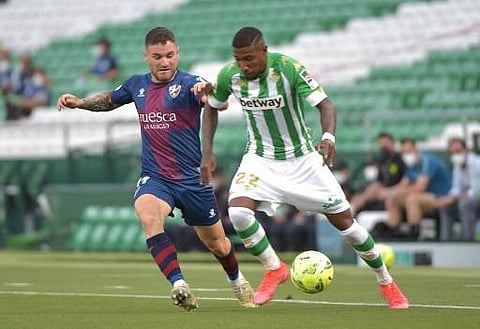 Huesca's Spanish defender Javi Galan (L) vies with Real Betis' Brazilian defender Emerson Aparecido 'Royal' (Photo | AFP)