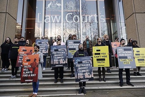 Greenpeace supporters demonstrate outside the Federal Court in Sydney. (Photo | AP)