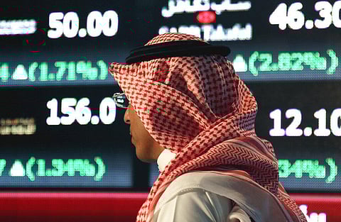 A Saudi man walks through the Tadawul Saudi Stock Exchange in Riyadh (Photo | AP)