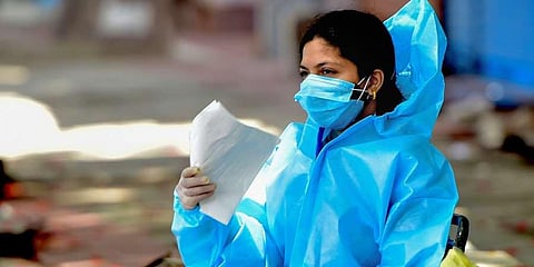 A health worker waits to conduct COVID-19 test. (Photo | PTI)