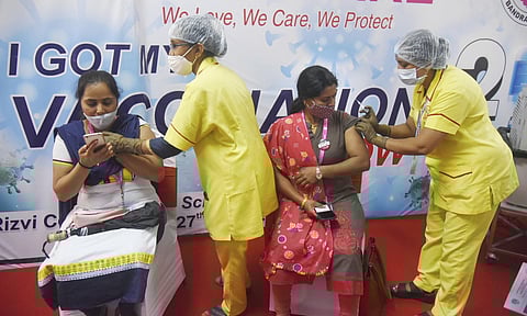Medics administer COVID-19 vaccines to families of Mumbai Police during an inoculation drive, organised by an NGO, in Mumbai, Saturday, June 19, 2021. (Photo | PTI)