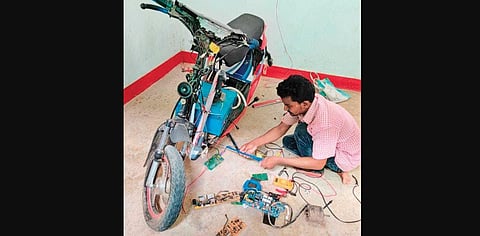 Laxman working on his ‘Intelligent Bike’