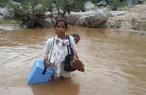 Manti Kumari crossing a river to reach a village in Mahuadanr Block of Latehar. (Photo | Special arrangement)