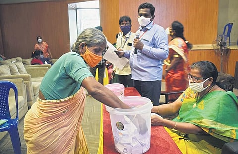 A woman takes part in a lottery for allotment of alternate housing, at Tummalapalli Kalakshetram in Vijayawada on Tuesday I Express
