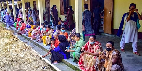 Beneficiaries wait in a queue to receive COVID-19 vaccine dose, at a centre in Nagaon district of Assam. (Photo | PTI)
