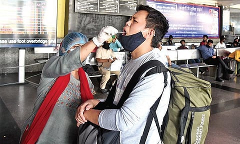 A health worker collects swab samples for Covid testing. (Photo |EPS/Parveen Negi)