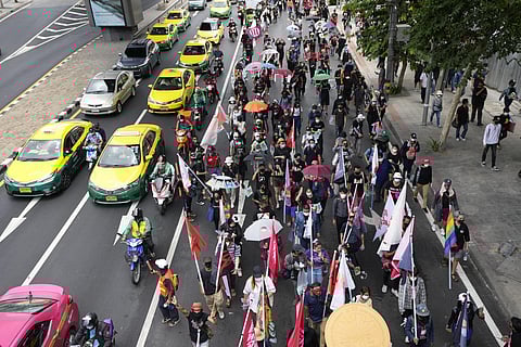 Pro-democracy supporters wearing face mask march on the road during a demonstration in Bangkok, Thailand, on Thursday. (Photo | AP)