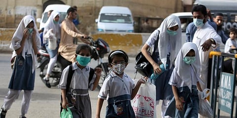 Student wearing face masks to help prevent the spread of the coronavirus arrive at a school in Karachi, Pakistan. (Photo | AP)