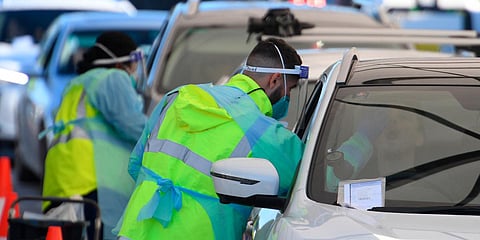 People queue in their cars to get tested for COVID-19 at a pop-up testing clinic at Bondi Beach in Sydney. (Photo| AP)