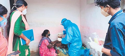 Medical team of Community Health Centre at Agali collecting sample for antigen test from 110-year-old Maruthi at her house at Vellamari ooru in Attappadi