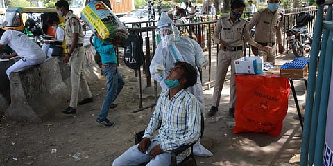A medic takes swab sample at a roadside collection site for COVID-19 testing. (File Photo | Shekhar Yadav, EPS)