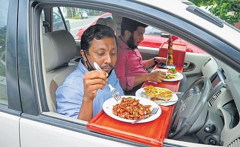 Customers enjoying food in their car in front of Zam Zam restaurant in Nanthancode. The service was recently launched by the restaurant| B P Deepu