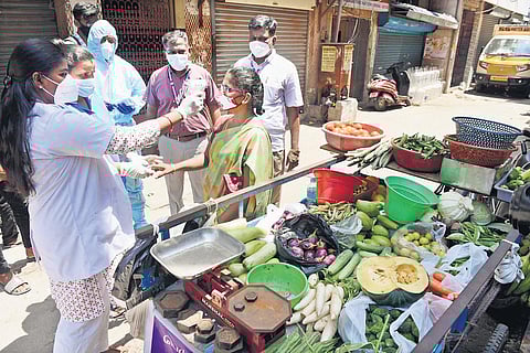 A health worker checking temperature near Wall Tax Road, in Chennai on Wednesday | R Satish Babu