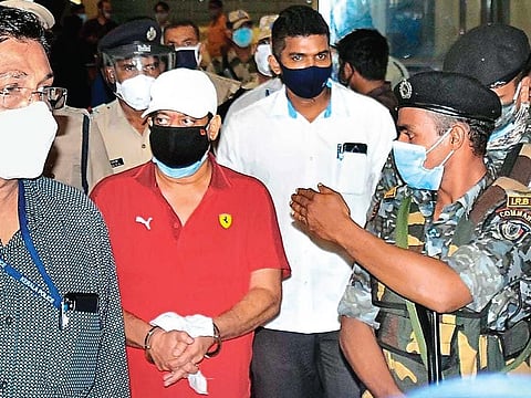 Gangster Ravi Pujari, accompanied by ATS officials and armed policemen, exits the Kochi airport on Wednesday | A Sanesh