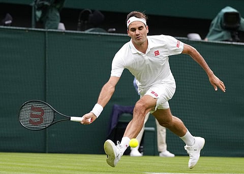 Switzerland's Roger Federer plays a return to Adrian Mannarino of France during the men's singles first round match against on day two of the Wimbledon. (Photo | AP)