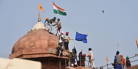 Farmers post flags on a dome of Red Fort after their tractor parade on Republic Day, in New Delhi (File photo | PTI)