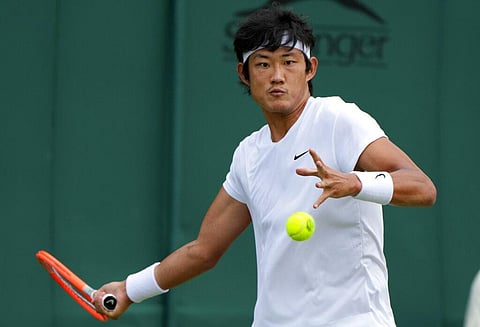 China's Zhizhen Zhang plays a return to Antoine Hoang of France during the men's singles first round match on day two of the Wimbledon. (Photo | AP)
