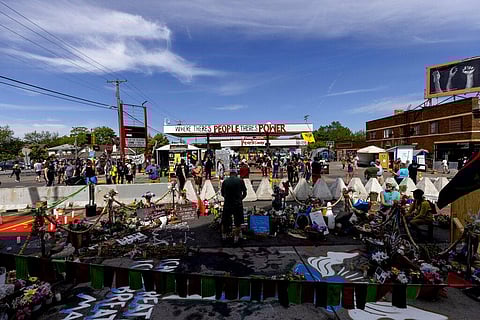 People walk by George Floyd Square in Minneapolis on Thursday(Photo | AP)