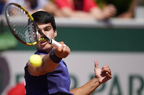 Spain's Carlos Alcaraz plays a return to Spain's Bernabe Zapata Miralles during their first round match on day two of the French Open tennis tournament. (Photo | AP)