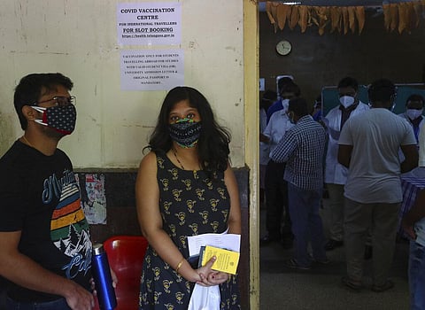 Students wait to receive the AstraZeneca vaccine during a special vaccination drive for students traveling abroad for studies in Hyderabad. (Photo | AP)