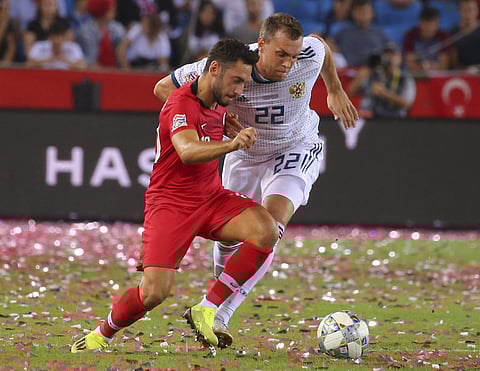 Turkey's Hakan Calhanoglu, left, fights for the ball with Russia's Artem Dzyuba, right, during the UEFA Nations League soccer match. (File | AP)