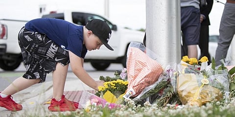 A child at the scene where a man driving a pickup truck struck and killed four members of a Muslim family in Ontario, Canada. (Photo | AFP)