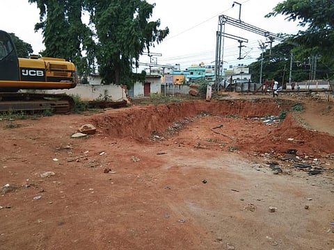 Road near Yelahanka railway station remains unusable as work begun to build an underpass ground to a halt in February. (Photo | Express)