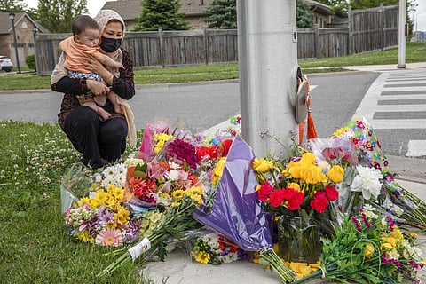 Nafisa Azima and her daughter Seena Safdari attend a memorial at the location where a family of five was hit by a driver, in London, Ontario, Monday, June 7, 2021. (Photo | AP)