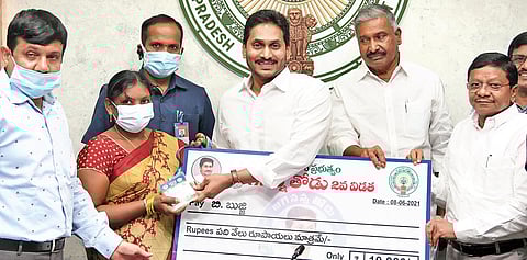 CM Jagan Mohan Reddy distributes aid under ‘Jagananna Thodu’ to a beneficiary at Tadepalli on Tuesday | Express