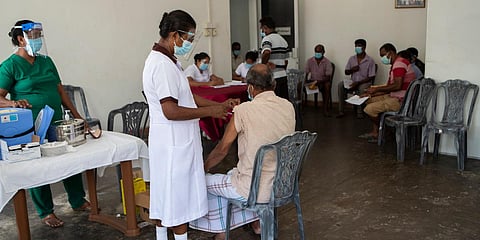 A Sri Lankan health worker administers the second dose of Covishield in Welisara near Colombo. (File photo| AP)