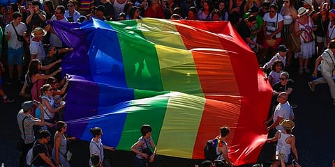 Participants of the annual LGBTQ pride parade carry the emblematic rainbow flag in Madrid, Spain. (Photo | AP)