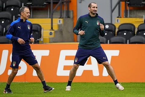 Italy's Giorgio Chiellini, right, warms up during a training session at the Hive stadium in London, England. (Photo | AP)