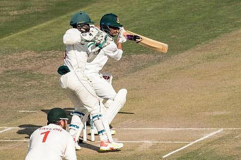 Bangladesh's Mahmudullah (R) plays a shot as Zimbabwe's wicketkeeper Regis Chakabva (C) looks on during the first day of the Test cricket match. (Photo | AFP)