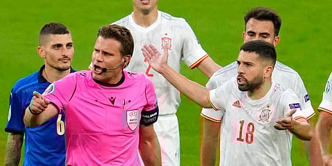 Spain's Jordi Alba, right, gestures to referee Felix Brych as they leave the field for the halftime break. (Photo | AP)