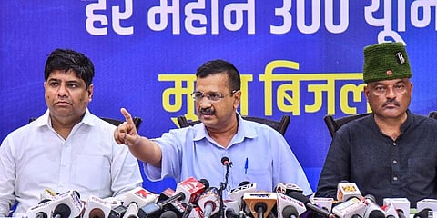 Delhi CM Arvind Kejriwal along with Uttarakhand State AAP in-charge Dinesh Mohaniya (L) and Colonel Ajay Kothiyal (R) address during a press conference in Dehradun, July 11, 2021. (Photo | PTI)